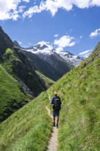 Mountaineers on a hiking trail in Umbaltal, glaciated mountain peaks in the background, Venediger