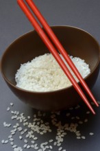 Rice, white rice in bowl with chopsticks, uncooked