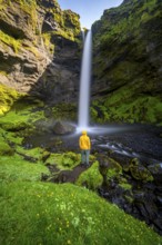 Tourist at Kvernufoss waterfall, in summer when the weather is nice, gorge and river, long
