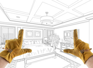 Male Contractor Hands Framing Over Custom Master Bedroom Design Drawing