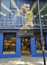 Shop front with a large mural of footballer Lionel Messi with trophy, La Boca neighbourhood, Buenos