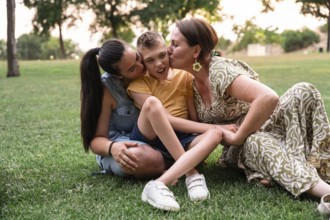 A family enjoying a sunny day in the park, showcasing love and connection with a disabled boy with