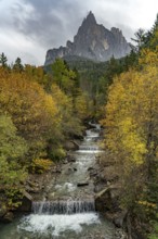 Autumn at the Schwarzgriesbach stream and the Schlern mountain in Seis am Schlern, South Tyrol,