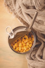 Open tin can, with corn, top view, selective focus, no people, close-up