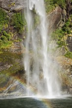 Rainbow over waterfall, Milford Sound, Fiordland National Park, South Island, Southland, New