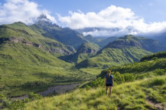 Young female hiker between mountains, Drakensberg National Park, KwaZulu Natal, South Africa