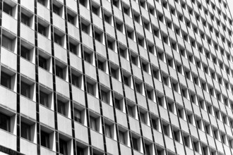 Black and white image of a building facade with repetitive square windows in Sidney, Australia.