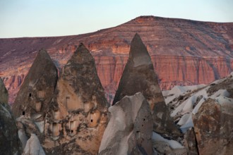 Rock carved dwellings in the dramatic cone shaped rocks of the Rose Red Valley, amazing Anatolian