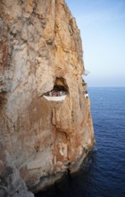 Cave in the rock used as a club, Cova den Xoroi, Menorca, Balearic Islands, Spain