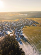 View of a wintry village with fields and forests in the sunset light, Neuweiler, district of Calw,