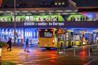 The main train station in Essen, blue illuminated underpass, bus station, am Europaplatz, train on