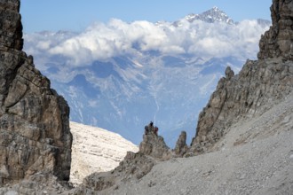 View through a flock of Cima Presanella, hikers on the Via Ferrate Benini via ferrata, Brenta