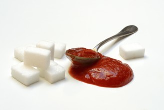 Ketchup in spoons and sugar cubes, sugar consumption