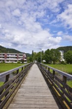 River Kinzig, pedestrian bridge, wooden bridge, hilly landscape with coniferous forest, residential