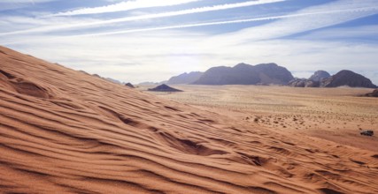 Captivating view over the red sand dunes in Wadi Rum Desert, Jordan, under a clear sky, with