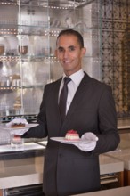 Waiter serving pastry at the Royal Mansour Hotel, Marrakesh, Marrakesh-Tensift-El Haouz region,