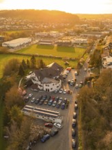 Street with parked cars and surrounding vegetation in a rural setting at sunset, Europäischer Hof,