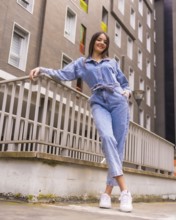 Young caucasian girl with a monkey cowboy and a black bag. Enjoying the city on vacation, lifestyle