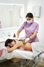 A qualified therapist provides a soothing massage to a client at a beauty salon specialized in