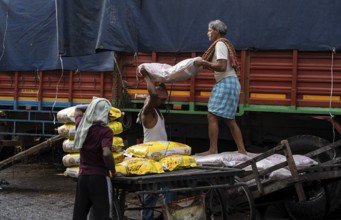 GUWAHATI, INDIA - MAY 1: Labourers carries goods in a wholesale market, in Guwahati, India, on May
