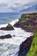 Cliffs, rocky beach and Atlantic Ocean in rainy weather, Seixal, Madeira, Portugal