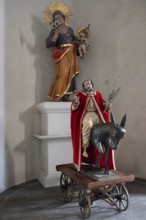 Palmesel, behind a sculpture of the Virgin Mary in the parish church of St Peter and St Paul,