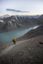 Mountaineer at Ala Köl mountain lake, in the Tien Shan Mountains, near Altyn Arashan, Kyrgyzstan