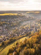 Aerial view of a village in autumnal colours with hills and trees at sunset, Sulz Calw, Black