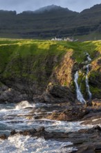 Houses against a mountain backdrop, rocky coast, sea, surf, Vidareidi, Vidoy Island, Viðareiði,