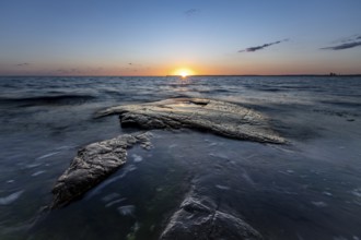 Rocks in the sea at sunset at Trönninge Stranden, Halmstad, Sweden