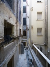 A detailed view of an urban renovation project, with exposed walls, construction materials, and