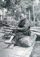 In Hang-Tcheou, farmer smoking his opium pipe