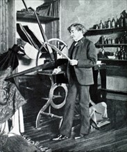 Painter James McNeil Whistler standing by his etching press (1903)