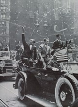 French pilots Costes and Bellonte waving at the cheering crowd on Broadway. They were the first pilots to fly from Paris to New York nonstop.