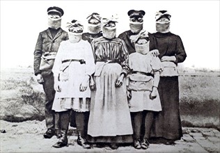 World War I. In Rheims, a family wearing gas masks (1916)