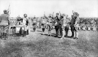 World War I. Serb volunteers pledging an oath before the flag and the Orthodox priest at the moment of enlisting on the Russian front (1918)