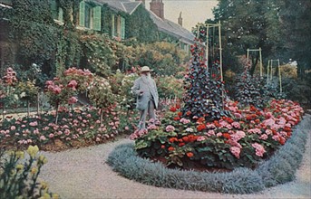Claude Monet in the garden of his house at Giverny