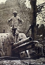 World War I. At Herbecourt, in the Somme, a telephone operator who helped adjust the aim, stands atop a German gun that he helped spot