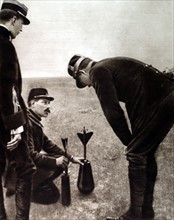 World War I. King Albert I of Belgium examining a bomb mechanism (1915)