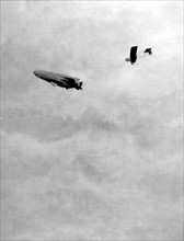 World War I. A Zeppelin being pursued by a French biplane (1915)