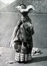 A baby out for a stroll in a Peruvian village (1913)