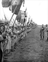 General Gouraud has gathered flags of all regiments of his army to salute a division who won battles in Verdun (1916)