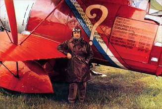 Pilote Dieudonné Coste posing next to the aircraft "Le Point d'Interrogation" (question mark), 1930