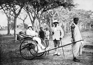 Prince Arini Oualino, son of former King Behanzin, on a stroll with his young wife, during a stay in Abomey, 1928
