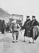 Korea : ; Japanese officers with a Korean porter