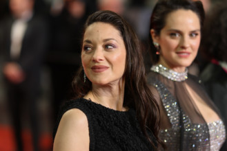 Noémie Merlant (in custom Louis Vuitton) and Marion Cotillard (in custom Chanel) attend the "Roma