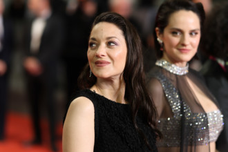 Noémie Merlant (in custom Louis Vuitton) and Marion Cotillard (in custom Chanel) attend the "Roma