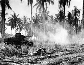 Australian soldiers backed up by a tank, New Guinea, 1943.