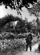 Painter Claude Monet in his garden