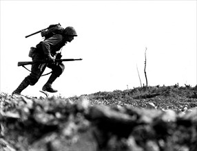 US soldier under the fire of the Japanese, at Okinawa 'Death Valley' (1945)